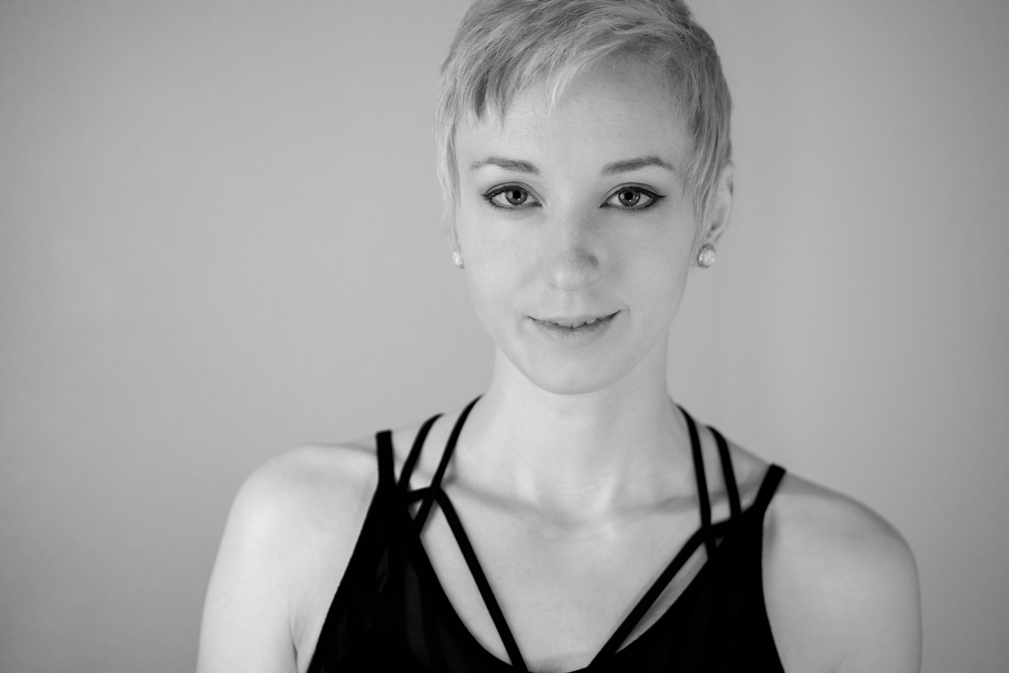 a black and white image of a short-haired woman staring at the camera